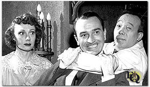 Peter Chan (R) holding Lee Bowman in a head lock while Judith Evelyn (L) looks on.&nbsp;